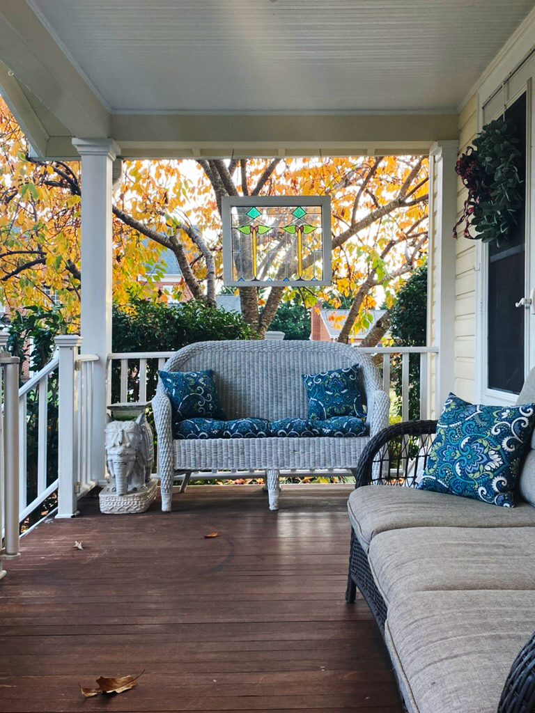 A photo of my front porch with fall foliage